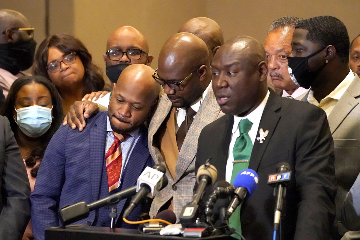 Philonise Floyd, center, brother of George Floyd, shares a hug with attorney Chris Stewart, left, as attorney Ben Crump speaks during a news conference after the verdict was read in the trial of former Minneapolis Police officer Derek Chauvin, Tuesday, April 20, 2021, in Minneapolis.