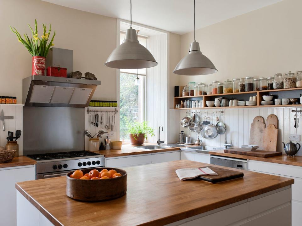 A kitchen with a wooden island.