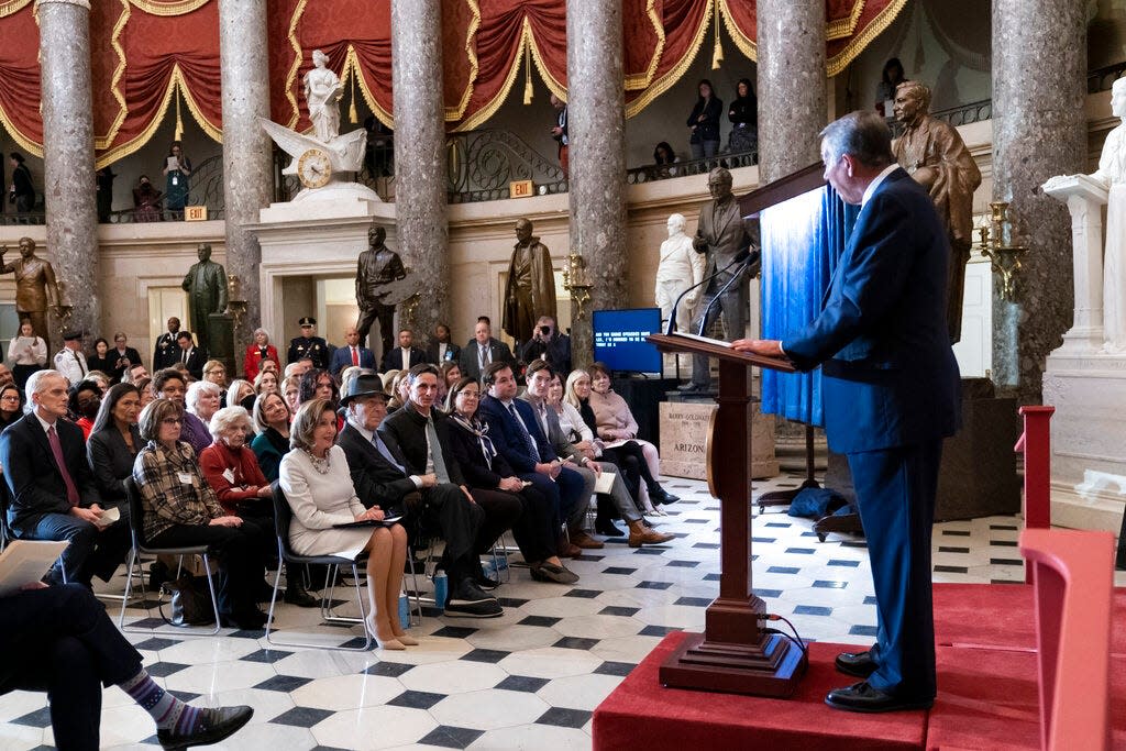 Speaker of the House Nancy Pelosi, D-Calif., seated at left, is joined by her husband Paul Pelosi as they listen to praise from former Republican Speaker John Boehner, right, during her portrait unveiling ceremony in Statuary Hall at the Capitol in Washington, Wednesday, Dec. 14, 2022.