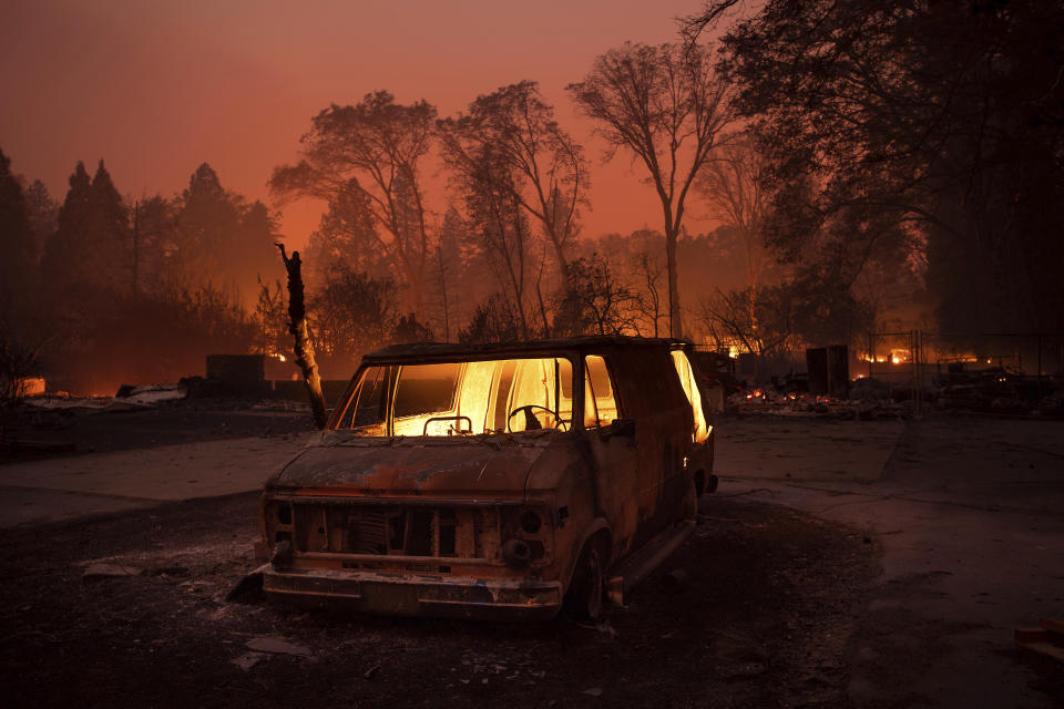 FILE - In this Thursday, Nov. 8, 2018 file photo, flames burn inside a van as the Camp Fire tears through Paradise, Calif. Authorities say the fire is 95 percent contained Thursday, Nov. 22. Paradise is about 140 miles north of San Francisco. (AP Photo/Noah Berger, File)