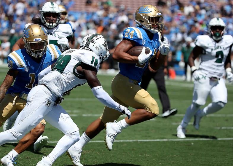 PASADENA, CALIF. - AUG. 28, 2021. UCLA running back Zach Charbonnet breaks free for a touchdown against Hawaii at the Rose Bowl on Saturday, Aug. 28, 2021. (Luis Sinco / Los Angeles Times)