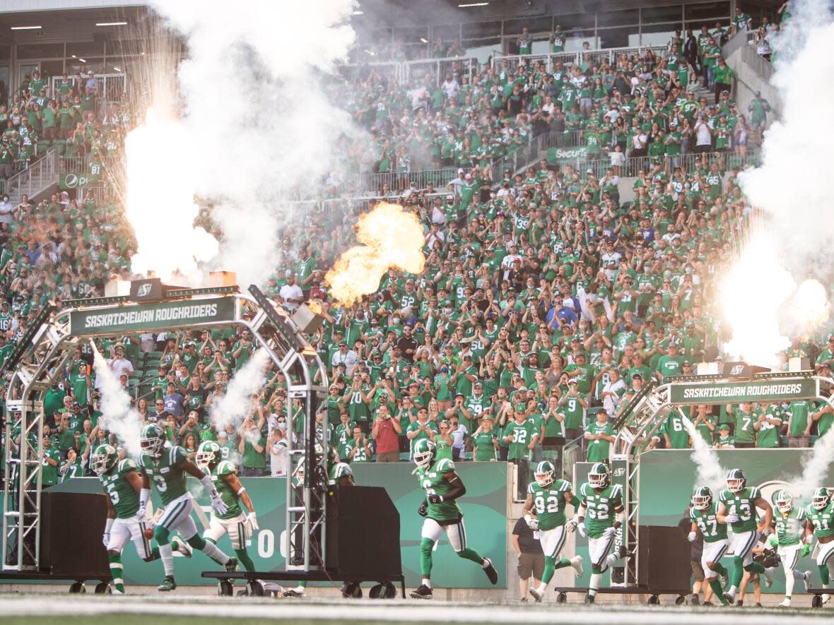 The Saskatchewan Roughriders, seen here before a game last September, will play the Winnipeg Blue Bombers in the pre-season opener on May 31.  (The Canadian Press - image credit)