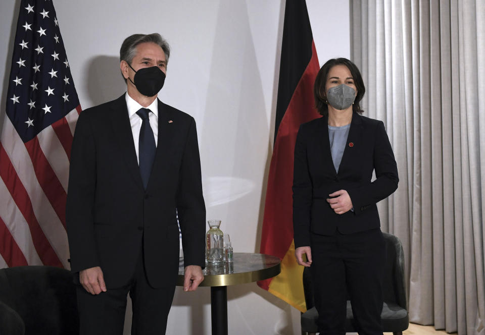 US Secretary of State Antony Blinken, left, and Germany's Foreign Minister Annalena Baerbock, wearing face coverings to combat the spread of the coronavirus, pose for a photograph before a bilateral meeting ahead of the G7 foreign ministers summit in Liverpool, England, Friday, Dec. 10, 2021. Blinken arrived in Britain for a G7 ministers' meeting before visiting Indonesia, Malaysia and Thailand. (Olivier Douliery/Pool Photo via AP)