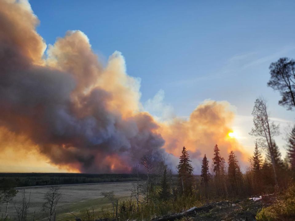 FORT NELSON, BRITISH COLUMBIA, CANADA - MAY 14: Smoke rises after fire erupts in Western Canada on May 14, 2024. Wildfires in Western Canada prompted thousands to flee their homes, while 66,000 were on standby to evacuate as a fast-moving blaze threatened another community Saturday. A growing wildfire moved relentlessly toward Fort Nelson, British Columbia (B.C.), resulting in officials ordering more than 3,000 to leave their homes in Fort Nelson and nearby Fort Nelson First Nation.Within five hours, the fire had grown to 8 square kilometers. (3 square miles) from a modest half square kilometer.Tinder dry conditions and flames fanned by powerful winds caused the wildfire to spread and prompted the evacuation order, which was issued at 7.30 p.m. (Photo by Cheyenne Berreault/Anadolu via Getty Images)