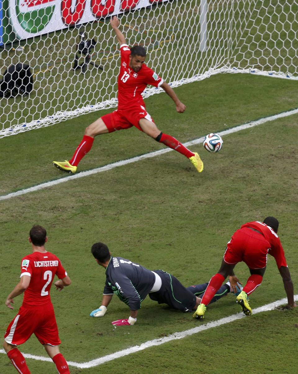 Switzerland's Ricardo Rodriguez (13) makes a save during their 2014 World Cup Group E soccer match against Honduras at the Amazonia arena in Manaus June 25, 2014. REUTERS/Andres Stapff (BRAZIL - Tags: SOCCER SPORT WORLD CUP)