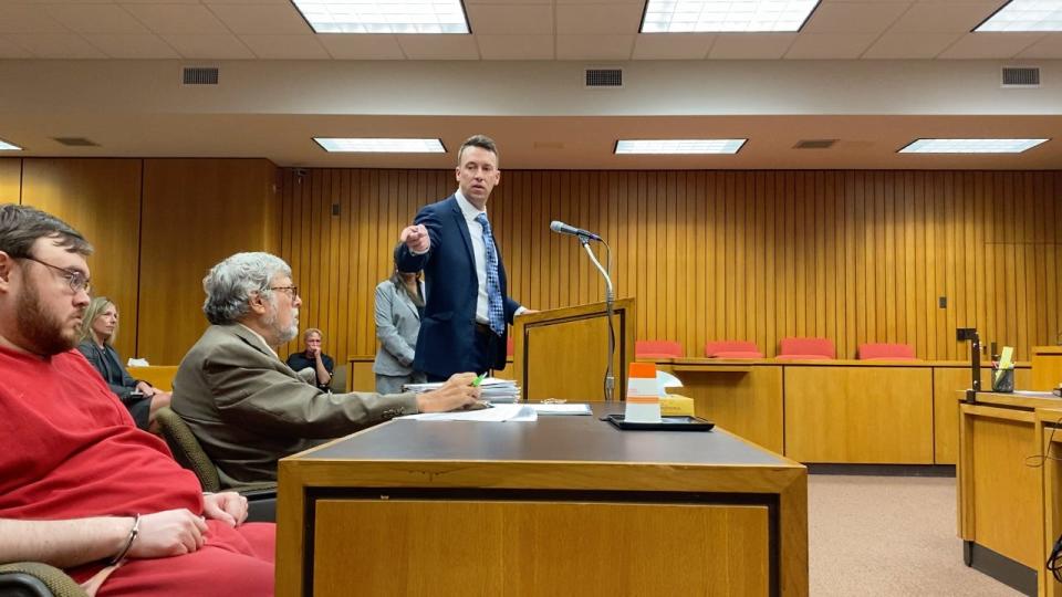 Craig Frederick, grandson of Glen Harold Meyers, gestures at Alarik John Guajardo of Adrian, left, Friday during Guajardo's sentencing in Lenawee County Circuit Court for murdering Meyers in the Adrian Meijer store Sept. 16, 2020, in this image taken from video. Also pictured is Guajardo's attorney, Lenawee County Chief Public Defender John Glaser.