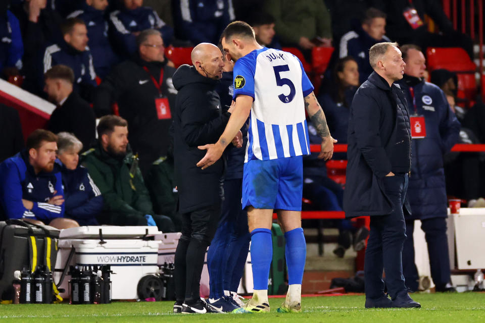 NOTTINGHAM, ENGLAND - NOVEMBER 25: Lewis Dunk of Brighton & Hove Albion talks to Fourth Official, Andy Davies after being shown a red card during the Premier League match between Nottingham Forest and Brighton & Hove Albion at City Ground on November 25, 2023 in Nottingham, England. (Photo by Marc Atkins/Getty Images)