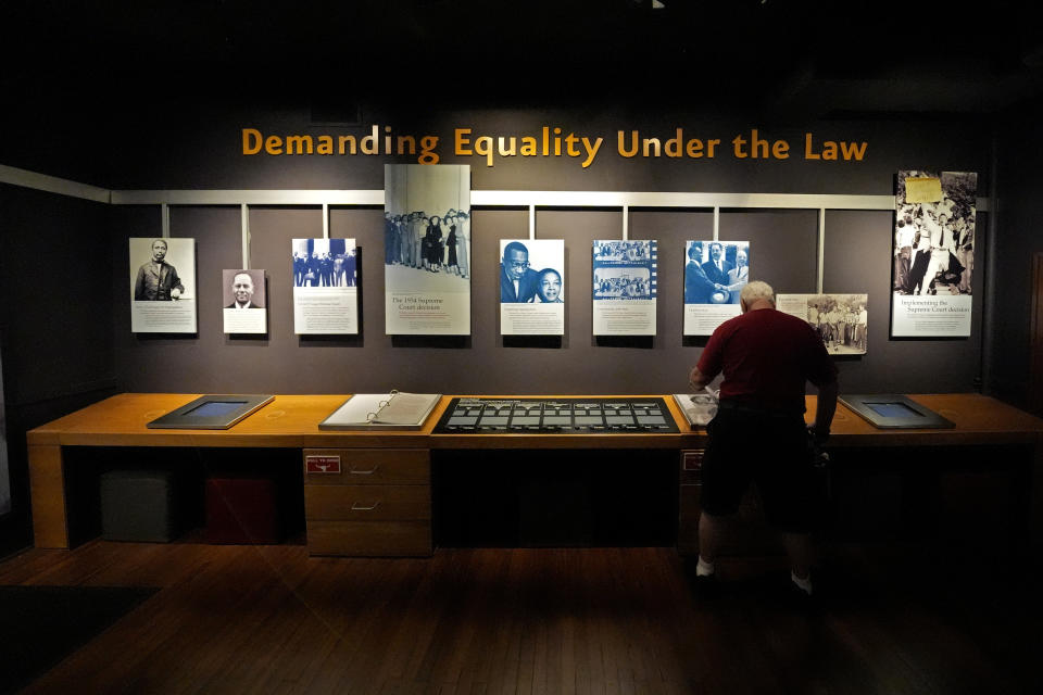 A man views an exhibit in the former Monroe school, which now houses a national historic site, Friday, May 10, 2024, in Topeka, Kan. The school was at the center of the Brown v. Board of Education Supreme Court ruling ending segregation in public schools 70 years ago. (AP Photo/Charlie Riedel)