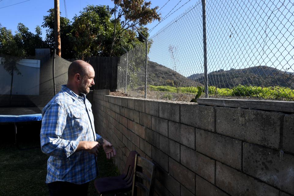 Jack Dempsey, a resident of the unincorporated Valley Vista community north of Ventura, looks out from his back yard at a field of grass on Dec. 12. A farmworker housing development is being proposed on the North Ventura Avenue property. Dempsey and several of his neighbors oppose the project, which is planned on property that had been a citrus orchard for decades.