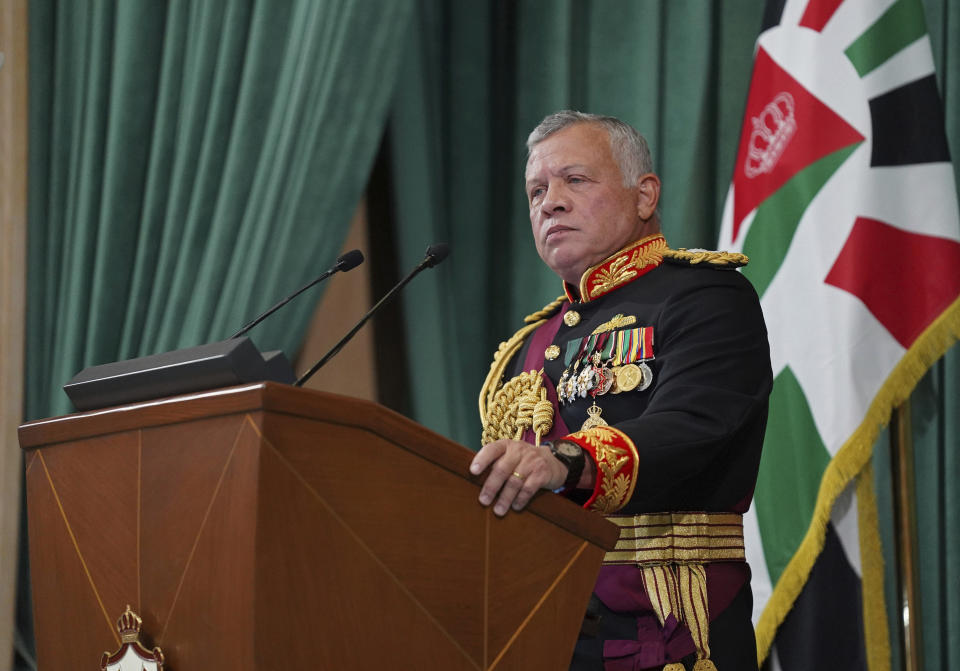 FILE - In this Dec. 10, 2020 file photo released by the Royal Hashemite Court, Jordan's King Abdullah II gives a speech to parliament, in Amman Jordan. Jordan's version of a trial of the century gets under way as early as Monday, June 21, 2021. A relative of King Abdullah II and a former chief of the royal court will be ushered into the defendants’ cage at the state security court to face sedition charges. They are accused of conspiring with Prince Hamzah, a half-brother of the king, to foment unrest against the monarch. (Yousef Allan/The Royal Hashemite Court via AP, File)