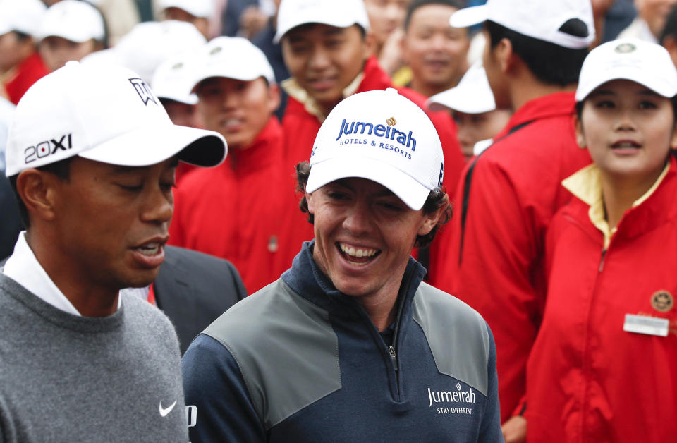 Tiger Woods of the United States, left, and Rory McIlroy of Northern Ireland chat on their way to the tee-off on the first hole during their 18-hole medal-match at the Lake Jinsha Golf Club in Zhengzhou, in central China's Henan province, Monday, Oct. 29, 2012. McIlroy shot a 5-under 67 to beat Woods by one stroke in a head-to-head, 18-hole exhibition match between the world's two top-ranked golfers. (AP Photo/Alexander F. Yuan)