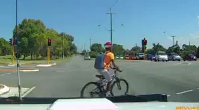 The cyclist, rides along Safety Bay Road, Waikiki, in Perth's south, as the white sedan approaches the T-intersection on the right of the screen. Source: Dash Cam Owners Association/Facebook