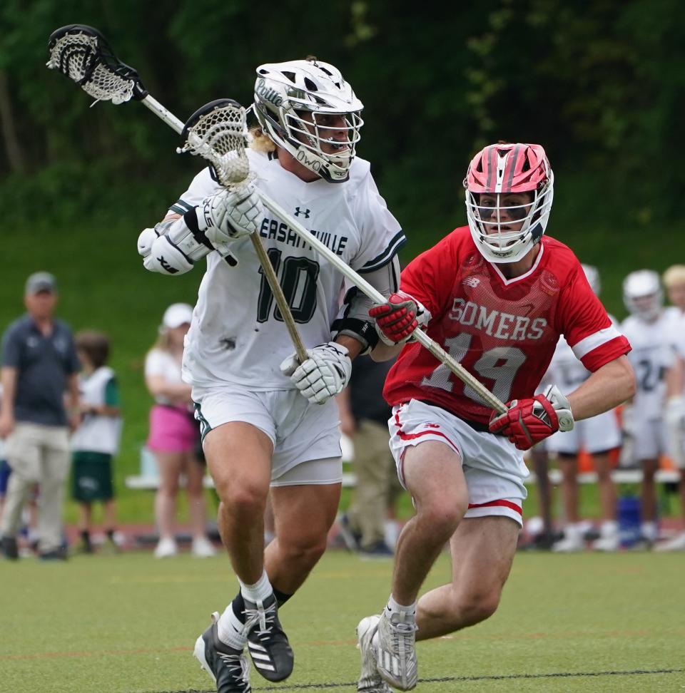 Pleasantville's Daniel Picart (10) works around Somers' Bret Kennedy (19) during their 11-10 overtime win in boys lacrosse at Pleasantville High School on Tuesday, May 14, 2024.