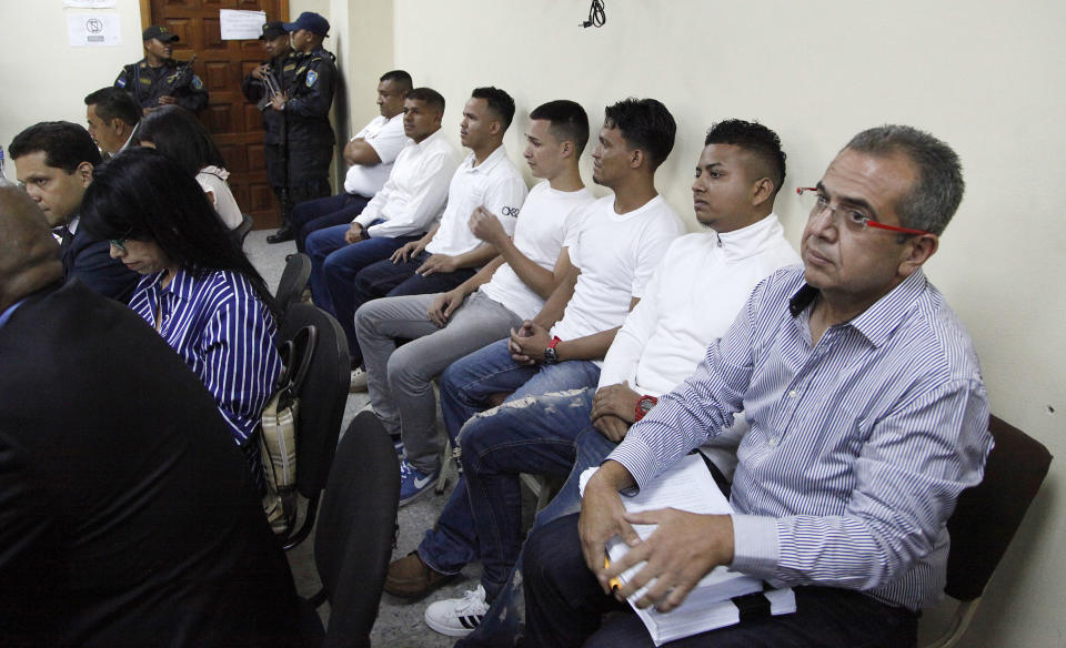 Men accused in the killing prize-winning Honduran indigenous and environmental rights activist Berta Caceres sit in a court room in Tegucigalpa, Honduras, Monday, Sept. 17, 2018. Honduras' supreme court has indefinitely suspended the start of the trial of eight men accused in the 2016 killing of Caceres, citing five related filings pending at the criminal appeals court that have to be resolved. (AP Photo/Fernando Antonio)