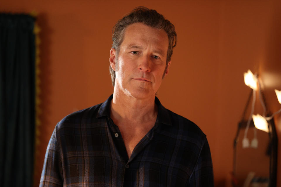 A close-up of John in a plaid shirt