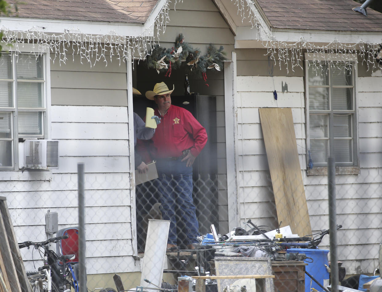 San Jacinto County Sheriff Greg Capers talks to investigators at the scene where five people were shot and killed the night before, Saturday, April 29, 2023, in unincorporated San Jacinto County, Texas. The suspect, Francisco Oropeza, who lives next door, is still at large. (Yi-Chin Lee/Houston Chronicle via AP)