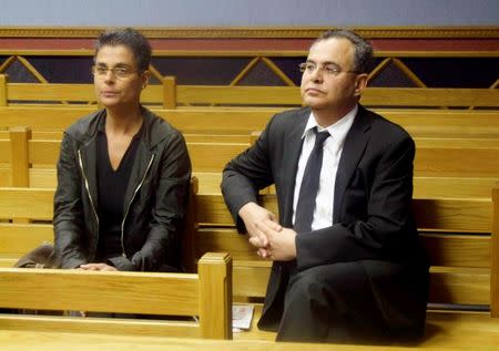 Fugitive U.S. millionaire Jacob "Kobi" Alexander sits with his wife Hanna, as he awaits the start of his extradition hearing in Windhoek, September 17, 2008. REUTERS/Stringer /File Photo