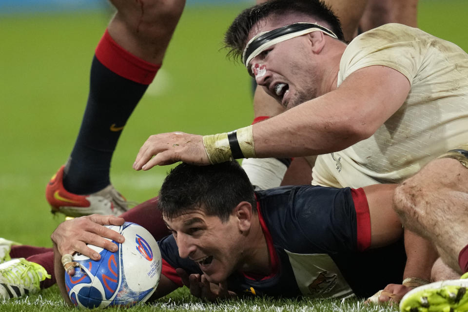 Argentina's Tomas Cubelli scores a try despite the tackle of England's Tom Curry during the Rugby World Cup third place match between England and Argentina at the Stade de France in Saint-Denis, outside Paris, Friday, Oct. 27, 2023. (AP Photo/Themba Hadebe)