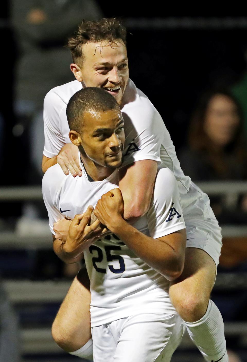 Akron midfielder Dyson Clapier (19) hops on the back of forward Terence Okoeguale (25) after his goal against Cleveland State during the first half of an NCAA college soccer game, Tuesday, Oct. 25, 2022, in Akron, Ohio.