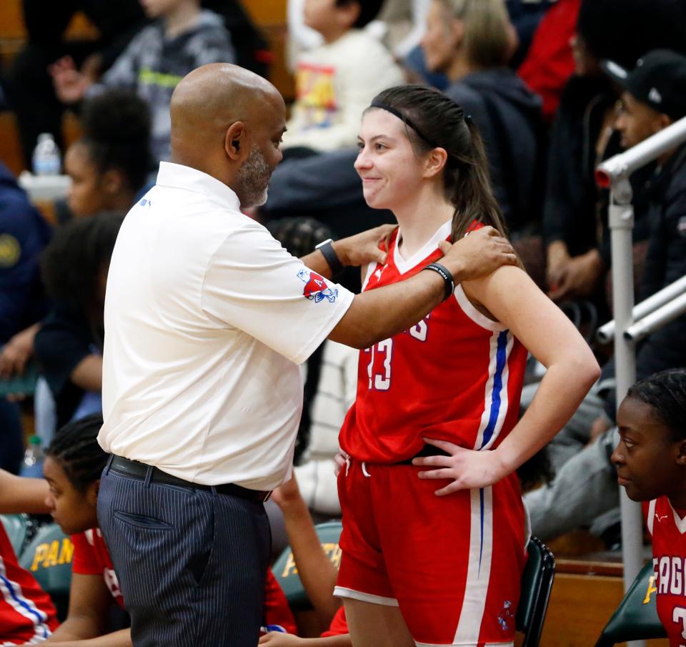 South Bend Adams coach Maurice Scott, left, talks with senior Meredith Anella late in the Class 4A, Sectional 3 girls basketball championship game against South Bend Washington Saturday, Feb. 3, 2024, at Washington High School.