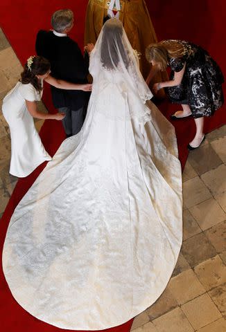 <p>Suzanne Plunkett - WPA Pool/Getty</p> Catherine Middleton has her dress adjusted by her sister and Maid of Honor Pippa Middleton as she arrives with her father Michael Middleton before her wedding at Westminster Abbey on April 29, 2011 in London, England.