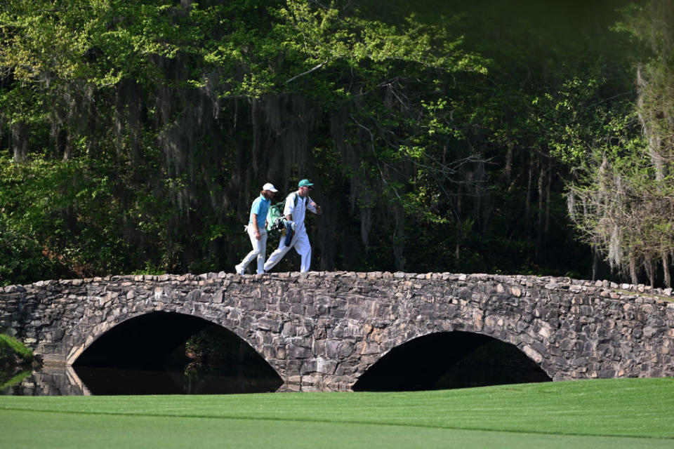 Tommy Fleetwood and his caddie Ian Finnis cross the Nelson Bridge on the 13th hole during their practice round today. GettyImages-1480061372