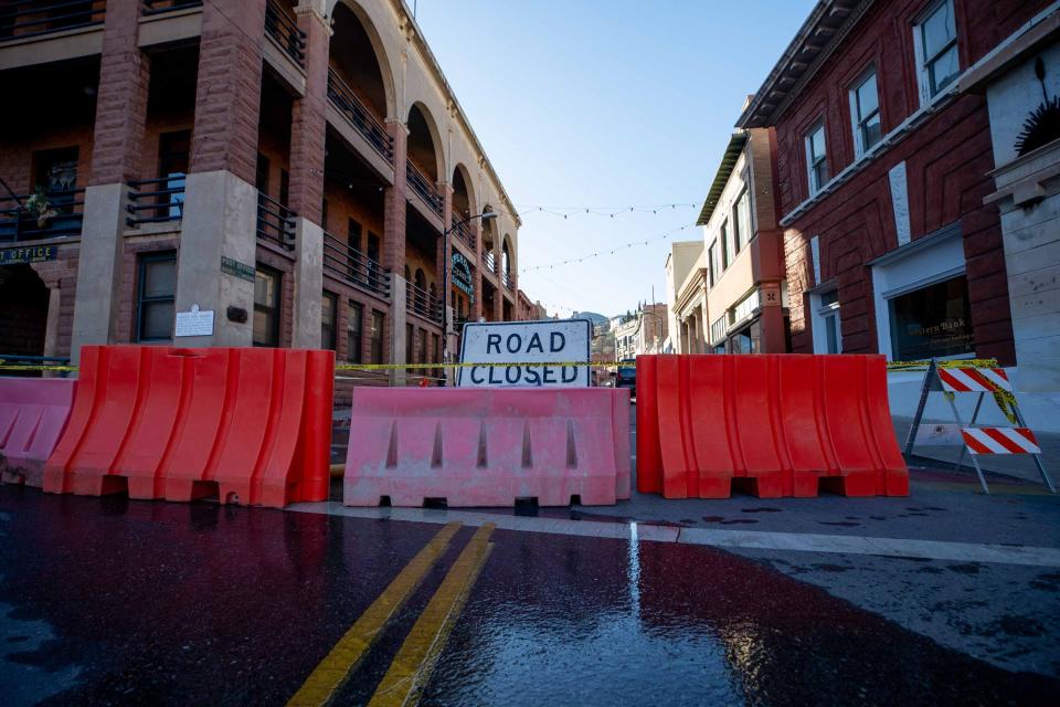 Firefighters hose down a building on Main St. in Bisbee, AZ on Feb. 15, 2024.