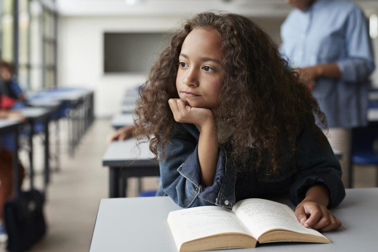 kid looking out window at school