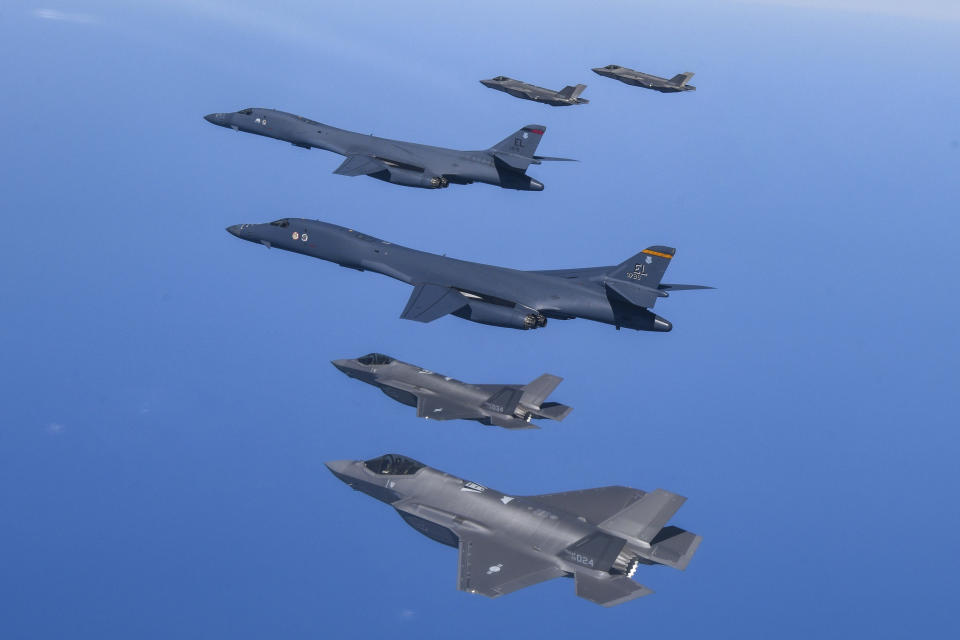 In this photo provided by South Korea Defense Ministry, U.S. Air Force B-1B bombers, center, fly in formation with South Korea's Air Force F-35A fighter jets over the South Korea Peninsula during a joint air drill in South Korea, Sunday, March 19, 2023. North Korea launched a short-range ballistic missile toward the sea on Sunday, its neighbors said, ramping up testing activities in response to U.S.-South Korean military drills that it views as an invasion rehearsal. (South Korea Defense Ministry via AP)