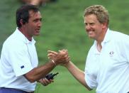 FILE - European Ryder Cup team captain Seve Ballesteros congratulates Scotland's Colin Montgomerie after he holed a putt on the 17th green to go one up in his fourball match on day two of the Ryder Cup at Valderrama golf coursein Valderrama, Spain, Saturday Sept. 27, 1997. Europe won in Spain to start three decades of never losing the Ryder Cup at home.(AP Photo/Elise Amendola, File)