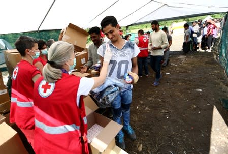 Migrants receive food and clothes at the migrant camp Vucjak in Bihac area