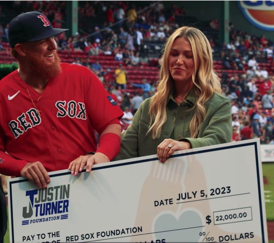 Justin Turner and his wife, Kourtney, present a check to the Red Sox Foundation earlier this year.