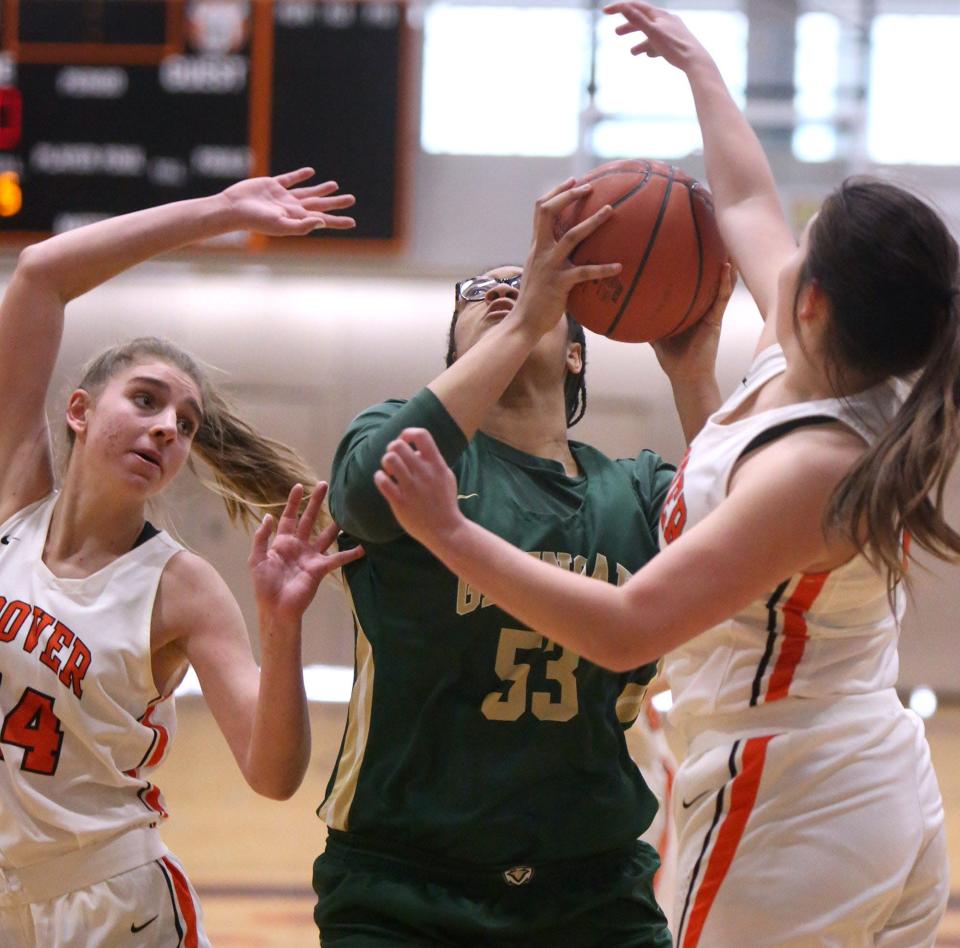 Jordan Weir, 53, of GlenOak fights for a rebound with Grace Craig, 44, and Lauren Rose, right, of Hoover during their game at Hoover on Saturday.