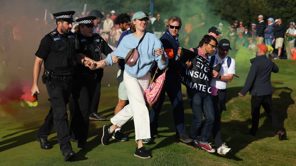 Protestors are led away by police. - Andrew Redington/Getty Images