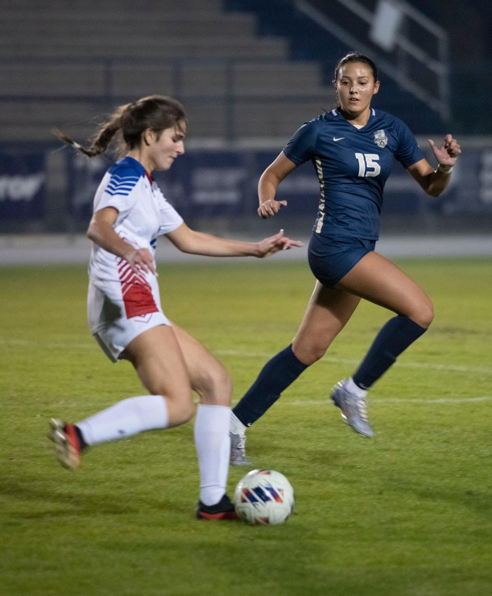 Gulf Breeze High's Jazmin Roltsch (No. 15) defends against the Pace High attack of mid-fielder Sadie Miller (No. 12) during a District 1-6A match on Wednesday, Nov. 29, 2023.