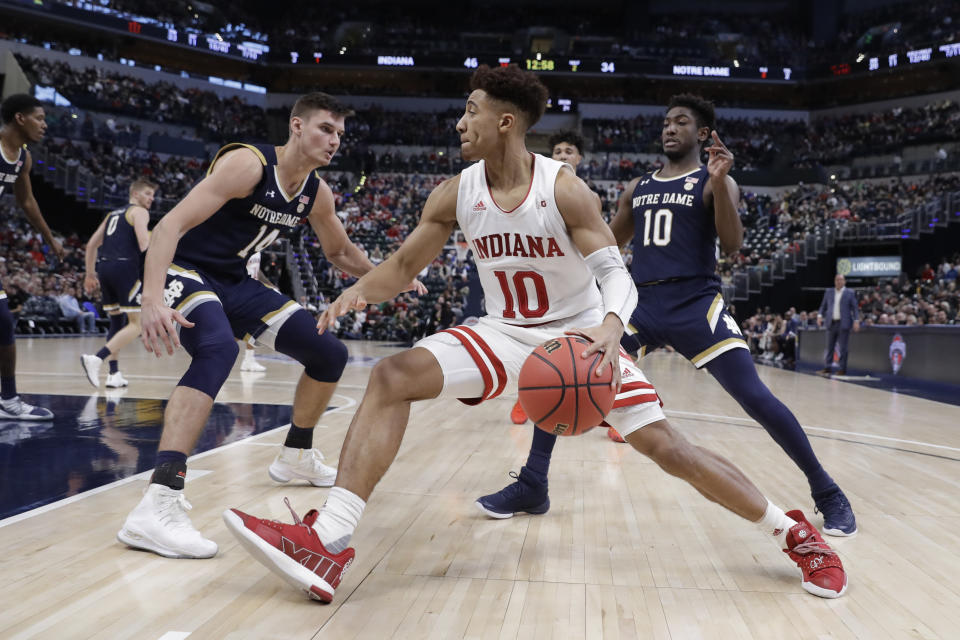 Indiana's Rob Phinisee (10) goes to the basket against Notre Dame's Nate Laszewski (14) and TJ Gibbs (10) during the second half of an NCAA college basketball game, Saturday, Dec. 21, 2019. Indiana won 62-60 (AP Photo/Darron Cummings)