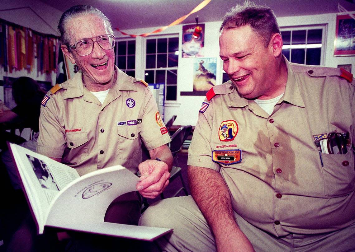Oct. 16, 2000: Ernest Doclar, left, the chartered organization representative, and John Quinn Jr., a troop committee member and merit badge counselor, laugh as they look through a Boy Scouts history book at a meeting at St. Francis Catholic Church in Grapevine. Doclar has been a member of Troop 7 for 20 years, and Quinn has been with the troop off and on for almost 40 years. Brian E. Harkin/Special to the Star-Telegram