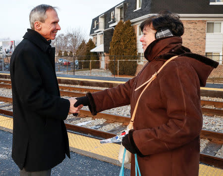 U.S. Congressman Daniel Lipinski (L) campaigns for re-election at the Chicago Ridge Metra commuter train station in Chicago Ridge, Illinois, U.S. January 25, 2018. Picture taken January 25, 2018. REUTERS/Kamil Krzacznski