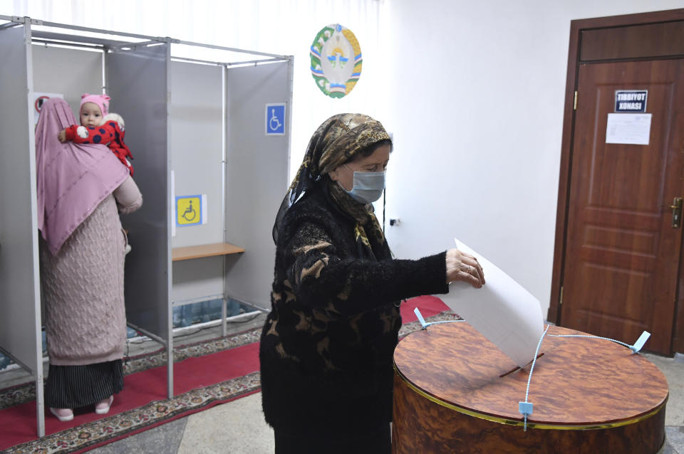 A woman casts her ballot at a polling station during the presidential election in Tashkent, Uzbekistan, Sunday, Oct. 24, 2021. Uzbekistan's President, Shavkat Mirziyoyev, who has relaxed many of the policies of his dictatorial predecessor but has made little effort at political reform, is expected to win a new term by a landslide against weak competition in an election Sunday. (AP Photo)