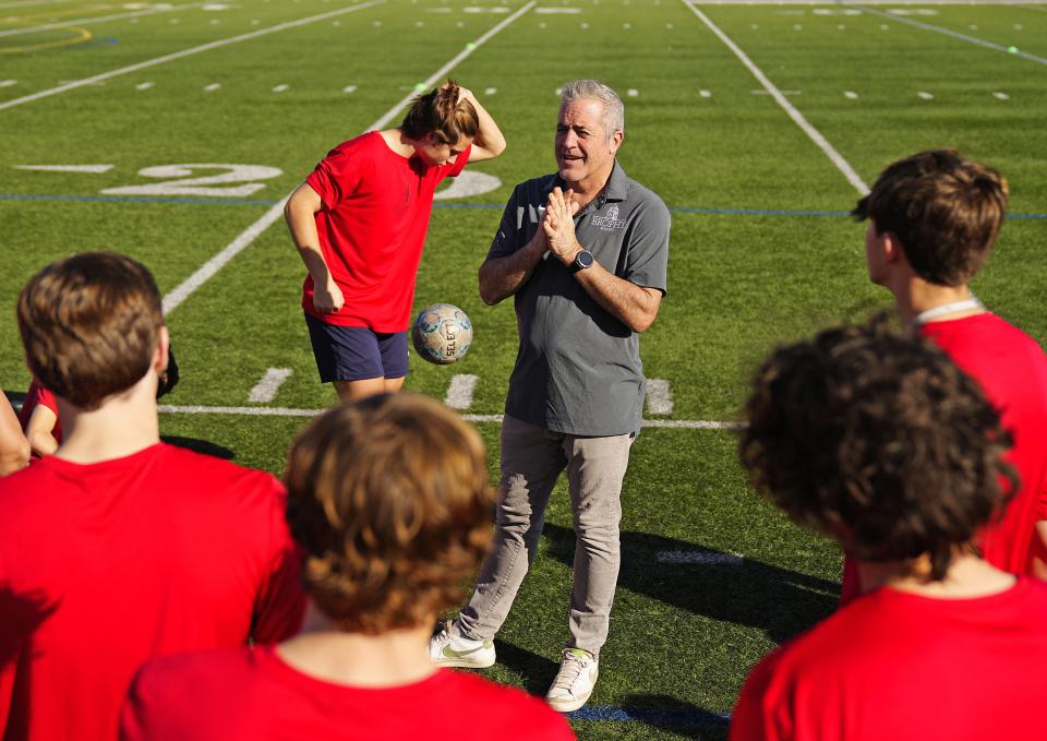 Brophy soccer head coach Marc Kelly talks with his team prior to practice on Jan. 19, 2023.