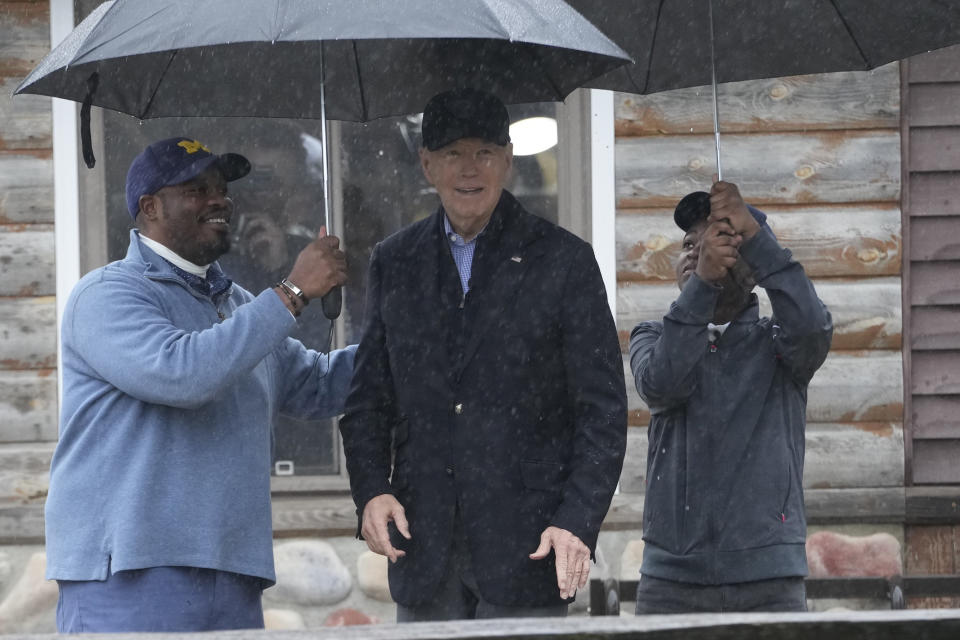 President Joe Biden poses for a photo with Hurley "HJ" Coleman IV and his father Hurley Coleman III, left, as he arrives for a campaign event at Pleasant View Golf Club in Saginaw, Mich., Thursday, March 14, 2024. (AP Photo/Jacquelyn Martin)