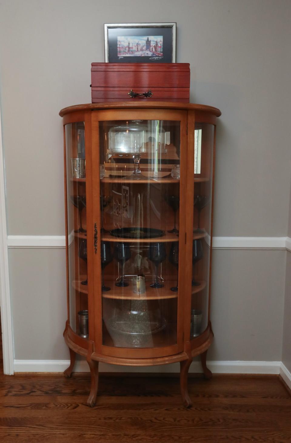 The curio cabinet in the dining room inside the ranch style home of Liz Toombs in Lexington, Ky. on June 22, 2023.