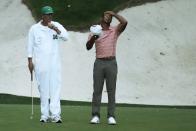 Tiger Woods wipes his head on the 13th green during the first round at the Masters golf tournament at Augusta National Golf Club Thursday, April 11, 2024, in Augusta, Ga. (AP Photo/Ashley Landis)