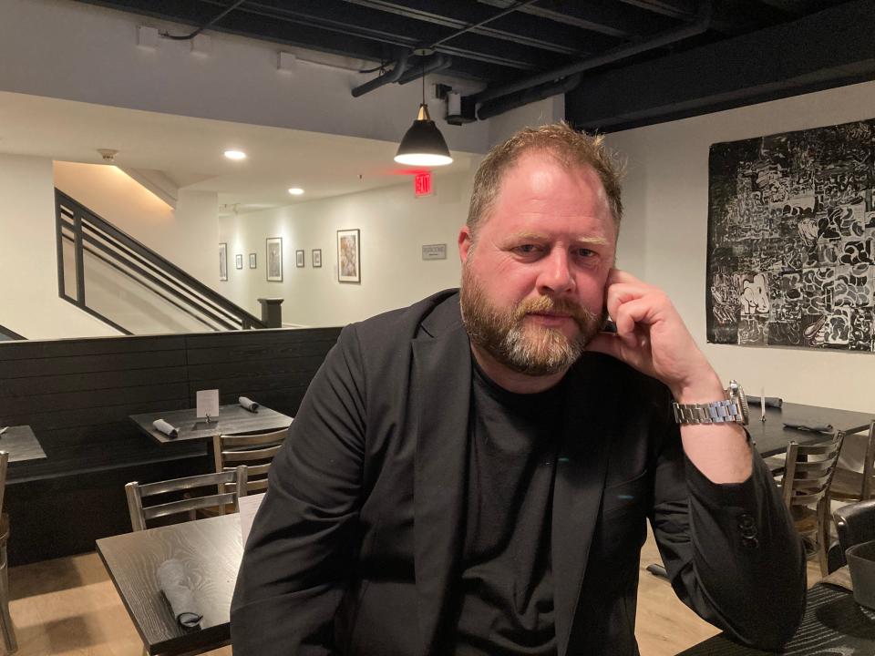 Thomas Christopher Greene, owner of Hugo's Bar & Grill, sits in the street-level dining room of the Montpelier restaurant Feb. 17, 2022.