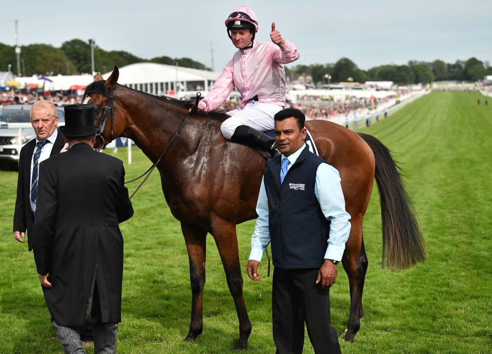 Jockey Seamie Heffernan poses for a photograph after riding Anthony Van Dyck to victory in the Derby Stakes.