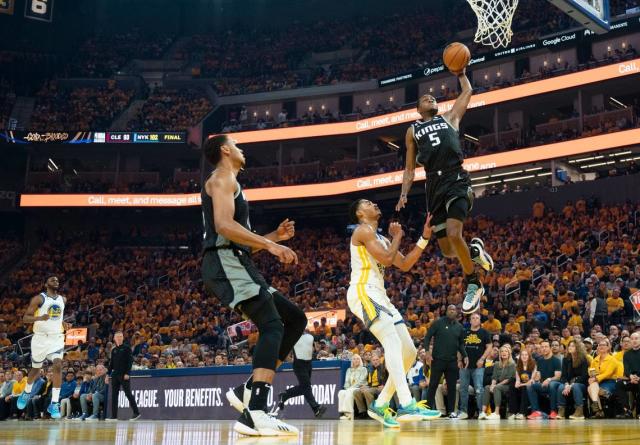 Sacramento Kings guard De&#x002019;Aaron Fox (5) dunks the ball defended by Golden State Warriors guard Jordan Poole (3) during Game 4 of the first-round NBA playoff series at Chase Center in San Francisco on Sunday, April 23, 2023.