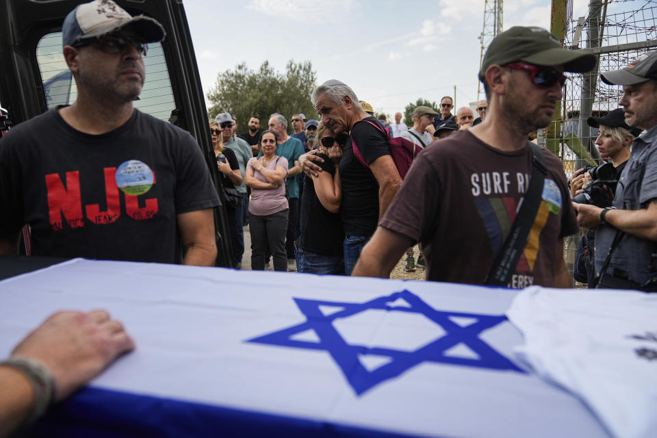 Mourners gather around the coffin of Yosef Vahav, 65, during his funeral in Beit Guvrin, Israel, Tuesday, Oct. 31, 2023. Vahav was killed by Hamas militants on Oct. 7 in Kibbutz Nir Oz near the border with the Gaza Strip. More than 1,400 people were killed and some 220 captured in an unprecedented, multi-front attack by the militant group that rules Gaza. (AP Photo/Ohad Zwigenberg)