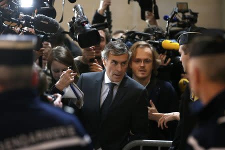 Former French budget minister Jerome Cahuzac (C), who resigned in 2013 after he admitted to have a Swiss bank account, arrives for the start of this trial for tax fraud at the courthouse in Paris, France, February 8, 2016. REUTERS/Charles Platiau