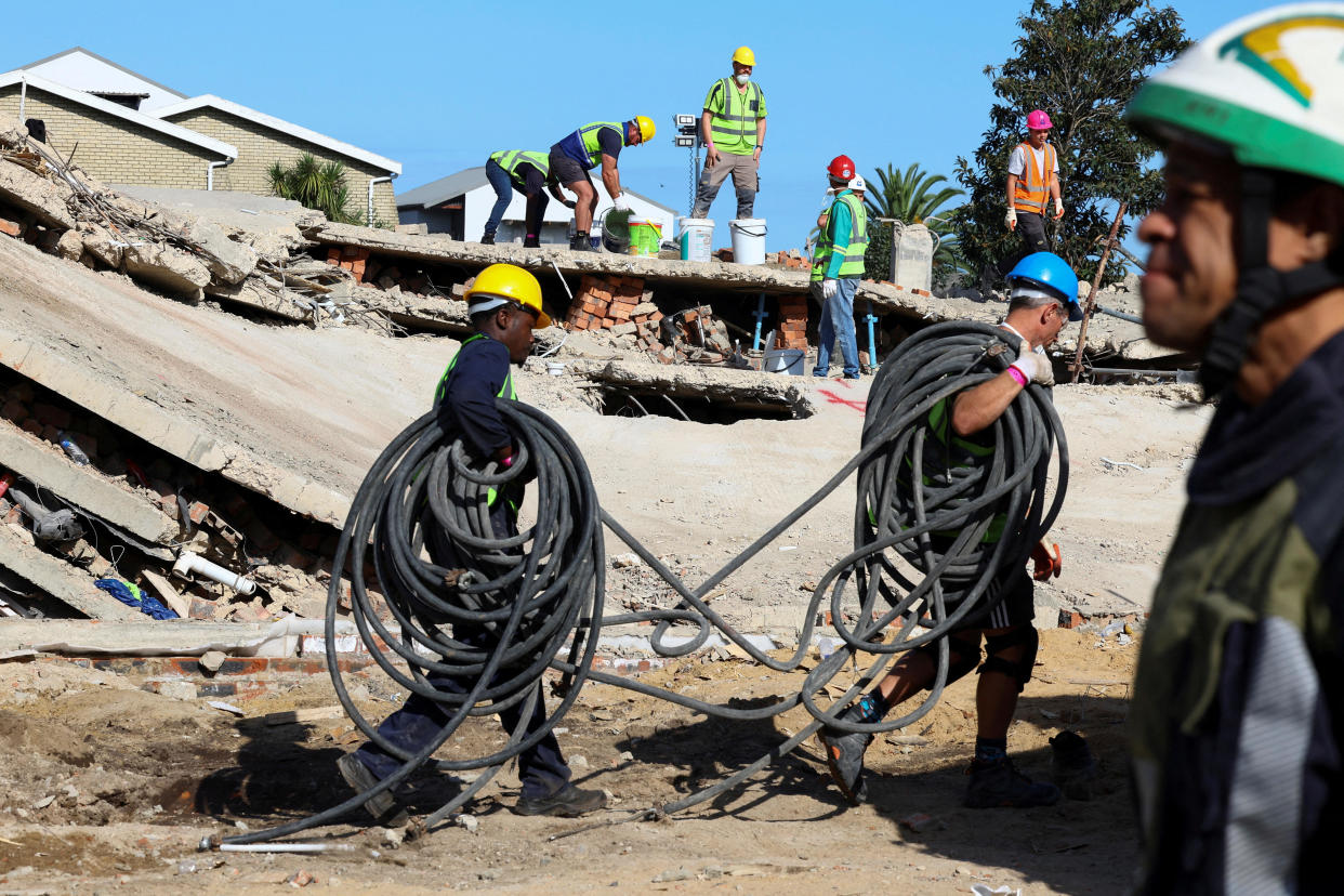 Rescuers try to find construction workers trapped under a building that collapsed in George, South Africa, May 8, 2024. / Credit: Esa Alexander/REUTERS