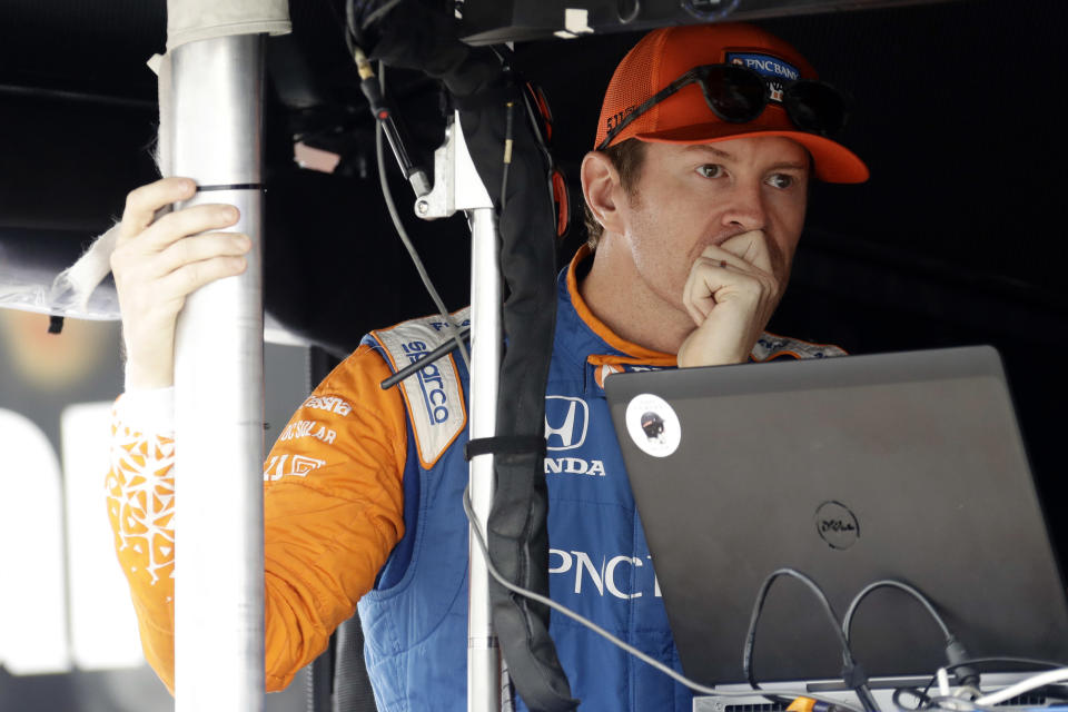 Scott Dixon waits in his pit box before a practice session for Sunday's IndyCar series auto race, Saturday, Aug. 18, 2018, in Long Pond, Pa. (AP Photo/Matt Slocum)